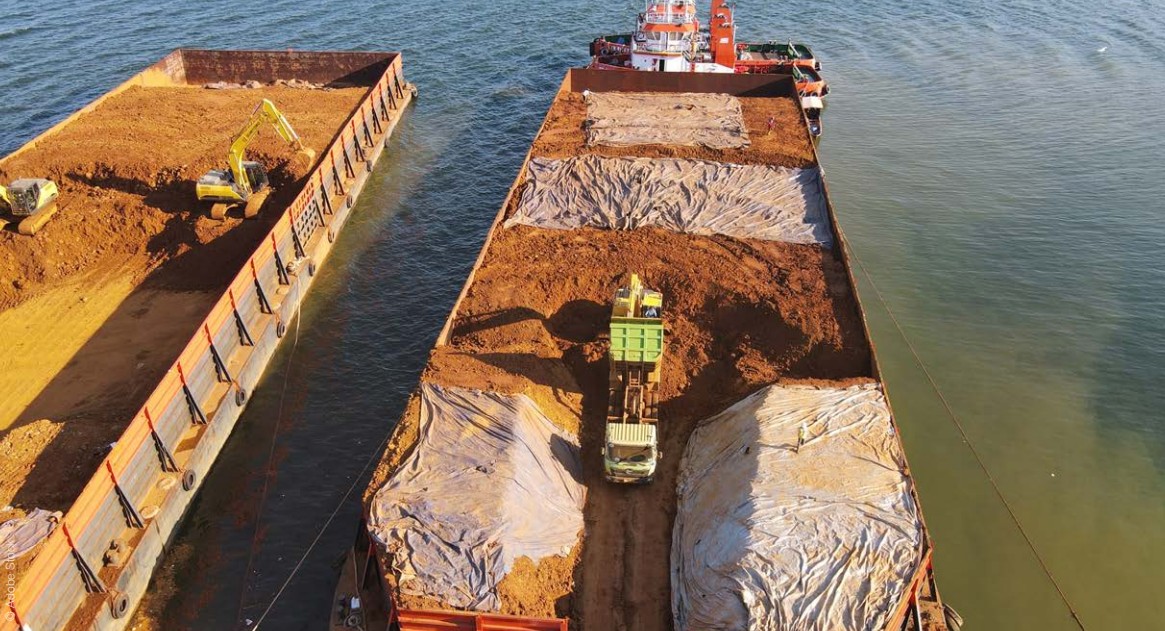 Critical minerals trade shown through bulk mineral cargo loading and maritime transport